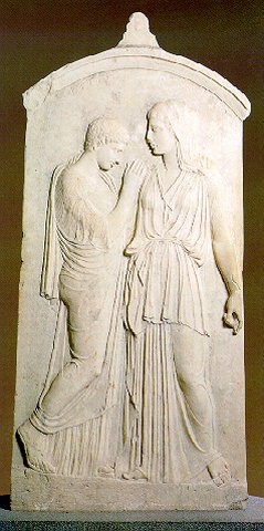 GRAVE STELE OF KRITO AND TIMARISTA - Grave stele of Krito and Timarista with two standing female figures. Timarista, fullface, in a chiton and peplos embraces Krito, who is dressed in a chiton and himation and has short hair. 420-410 BC. 
