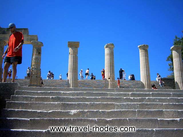 LINDOS ACROPOLIS - Hellenistic stoa with lateral projecting wings with tetrastyle facades (end of 3rd c. BC). The stoa is 87 m long and consists of 42 columns in all. The wall of the stoa was not all one, but wasinterrupred in the middle for a space of ten columns.