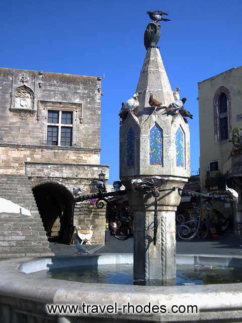 HIPPOCRATES SQUARE - Some pigeons on the monument in the midle of Hippocrates square in Rhodes old town